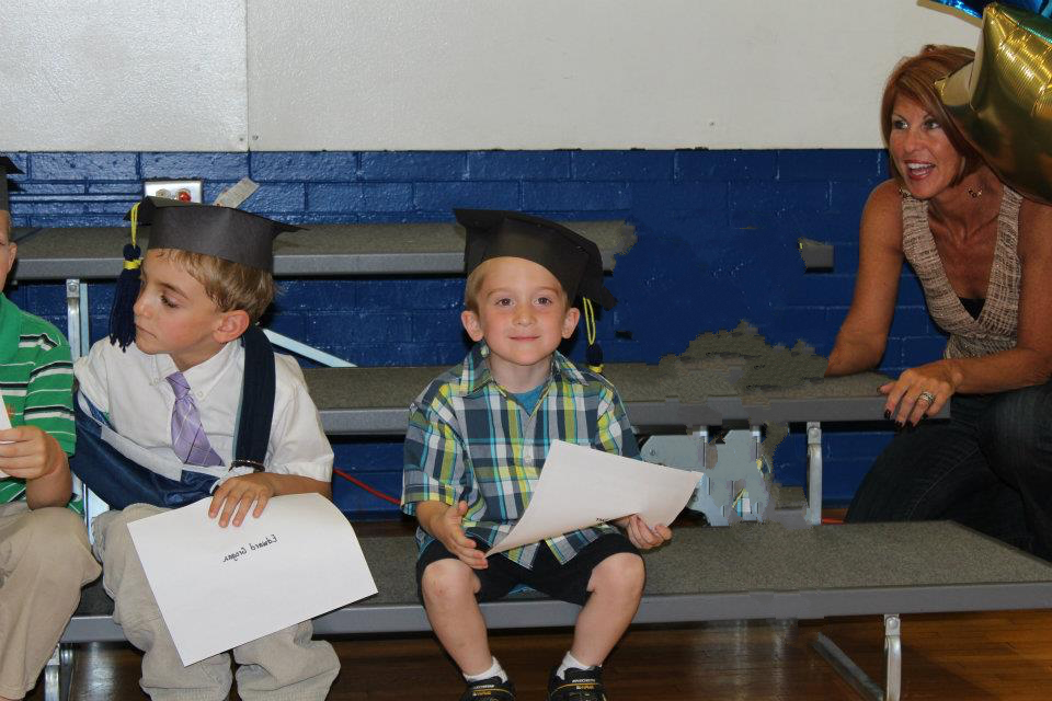 little aaron wearing graduation hat